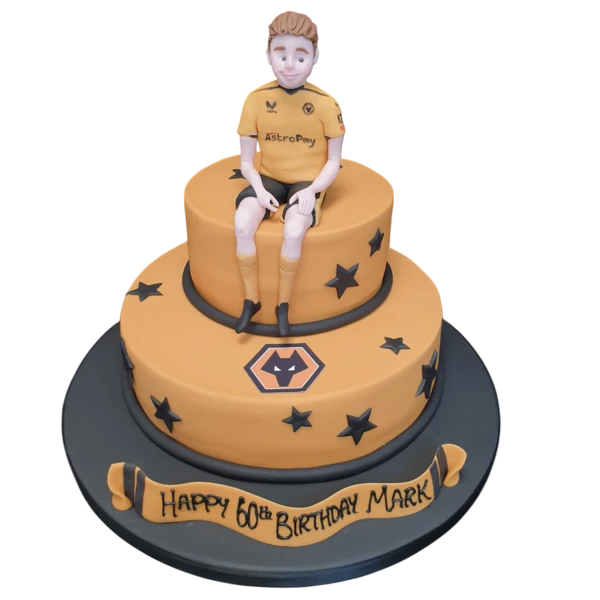 A beautifully decorated cake featuring the logos and colours of the Wolves football team, perfect for fans to celebrate their love for the club.