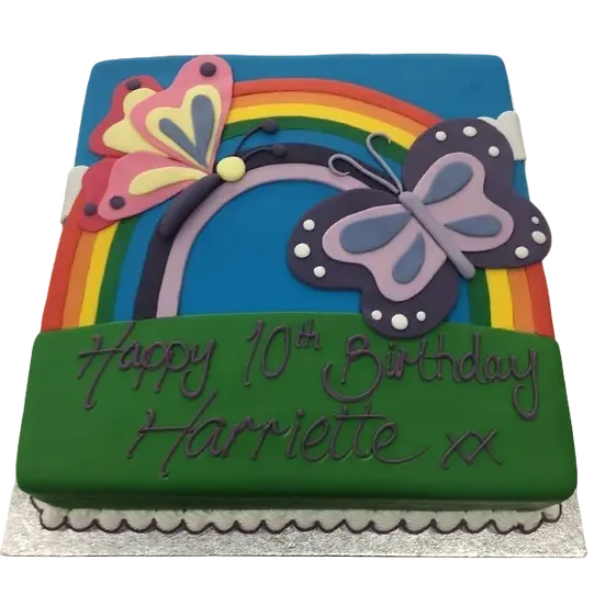 Bespoke celebration cake with colorful butterflies and a vibrant rainbow, crafted in Solihull, West Midlands.