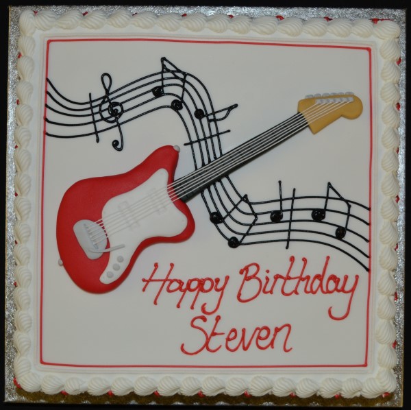 Bespoke square cake with guitar and music stave decoration, perfect for celebration in Solihull, West Midlands.