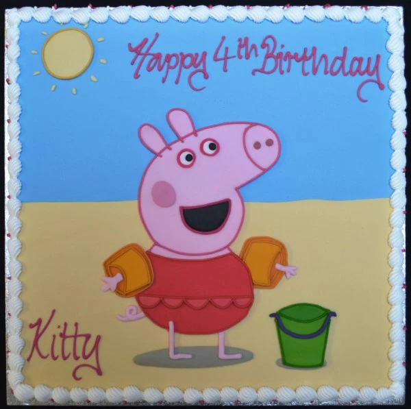A vibrant Peppa Pig-themed beach scene cake with colorful decorations and characters from the popular children's show. Perfect for fans of the beloved cartoon.