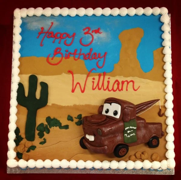 Bespoke celebration cake in Solihull, West Midlands featuring rusted car designs on a square base.