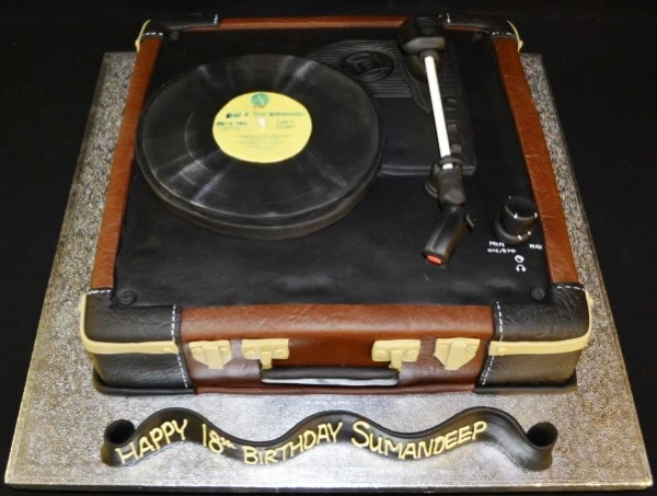 A creatively designed cake shaped like a vinyl record player, perfect for music lovers and special occasions in UK.