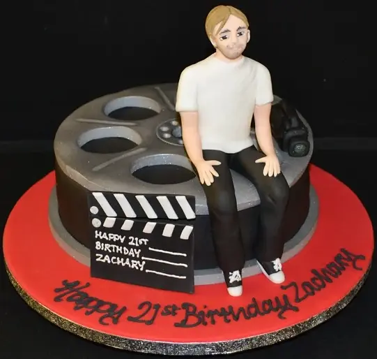 Bespoke film reel cake with edible film strips and a clapperboard design, crafted in Solihull, West Midlands.