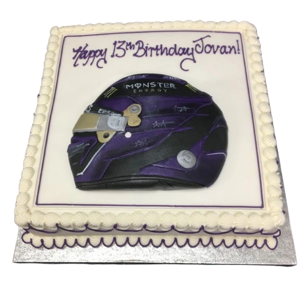 Bespoke Lewis Hamilton helmet cake with F1 details, crafted for celebration in Solihull, West Midlands.