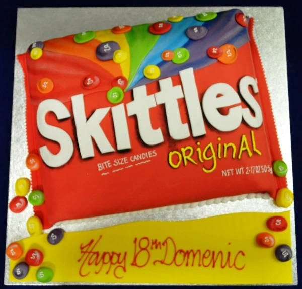 Vibrant bespoke Skittles cake with colorful candy decoration, perfect for celebration in Solihull, West Midlands.