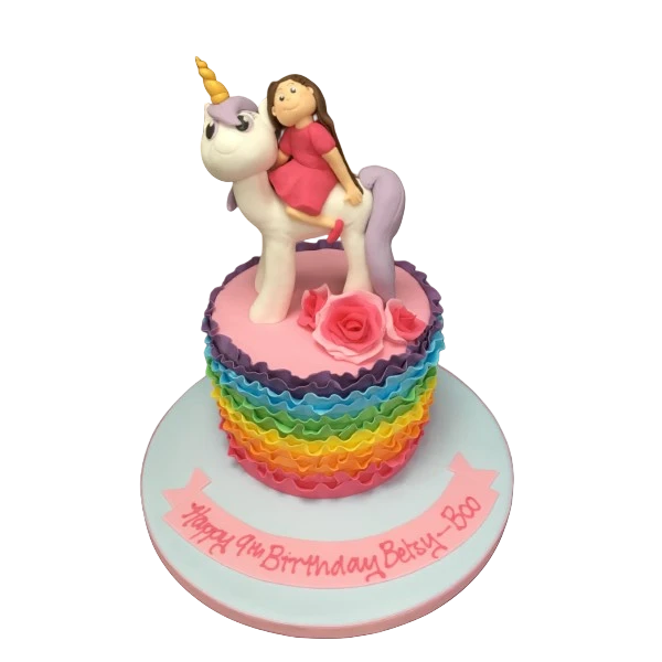 Rainbow ruffle cake with unicorn pony riding girl decoration, perfect for a magical celebration. Ideal for birthdays, parties, or special occasions.