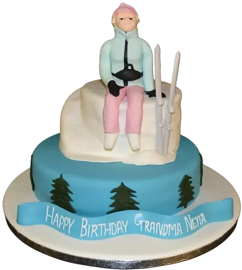 Bespoke cake featuring a skier figurine on snowy slopes, crafted for celebration in Solihull, West Midlands.