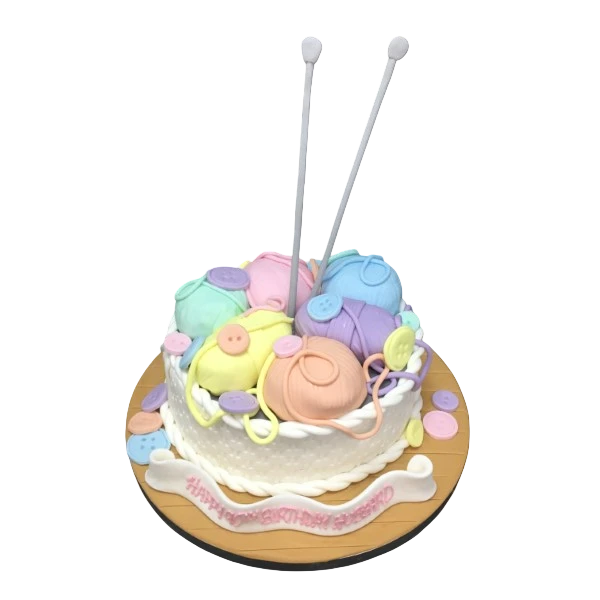 Bespoke knitting basket cake with edible yarn and needles, crafted for celebration in Solihull, West Midlands.