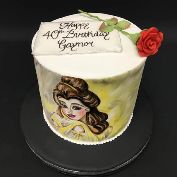 Bespoke celebration cake featuring a detailed Belle figure on tiered design, crafted in Solihull, West Midlands.