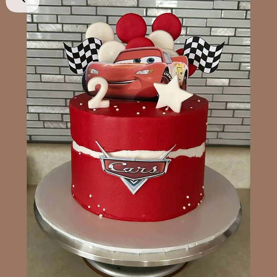 Bespoke single-tier cake with elegant white icing and delicate floral decorations, crafted in Solihull, West Midlands.