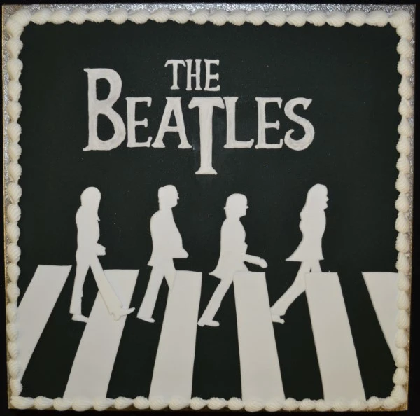 Bespoke Beatles-themed celebration cake with colorful square layers, crafted in Solihull, West Midlands.
