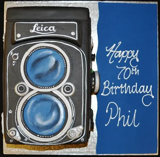 Bespoke Leica Camera cake with detailed lens and logo design, crafted for celebration in Solihull, West Midlands.