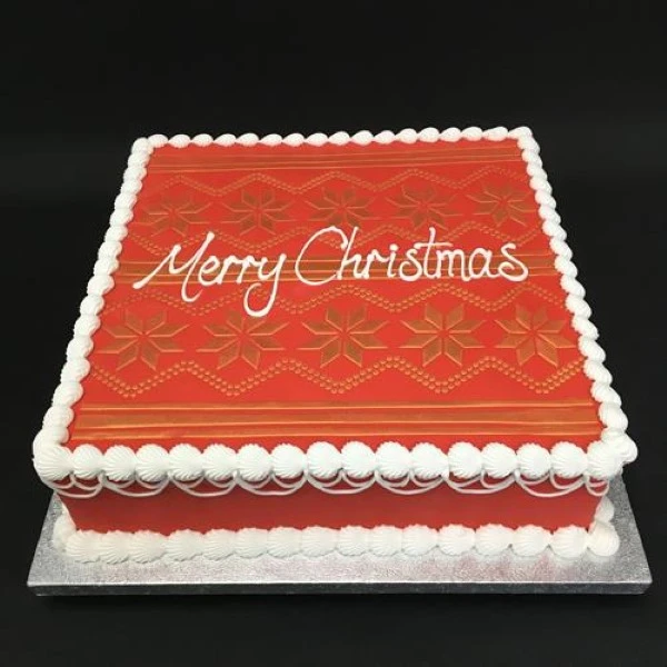 Festive Christmas jumper themed cake with colourful decorations perfect for holiday celebrations.