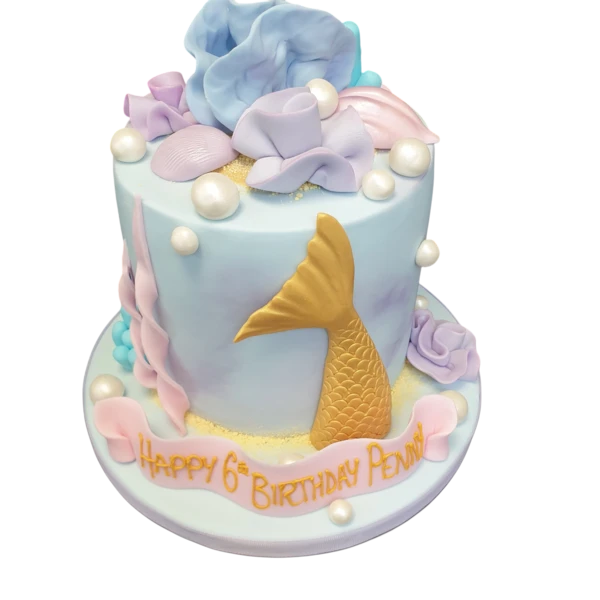 Bespoke under the sea mermaid cake with ocean waves and seashells, crafted in Solihull, West Midlands.