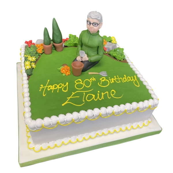 Bespoke Gardening Lady cake with edible flowers and garden tools, crafted in Solihull, West Midlands.