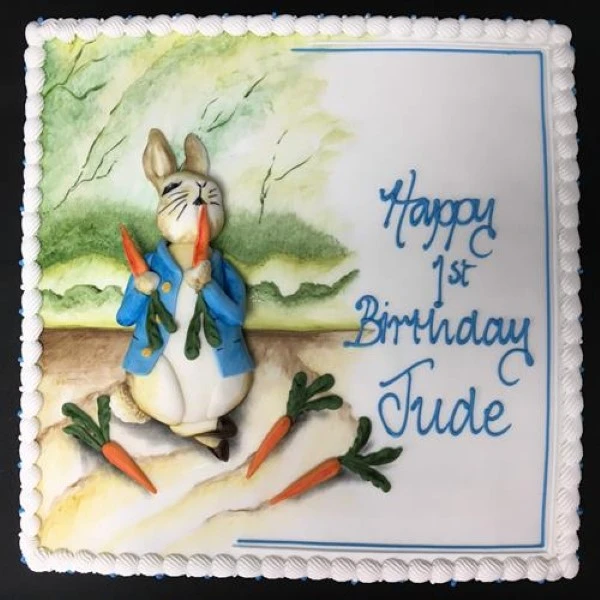 Adorable Peter Rabbit themed cake with a painterly design perfect for any special occasion or celebration. Handcrafted with intricate details and vibrant colors.