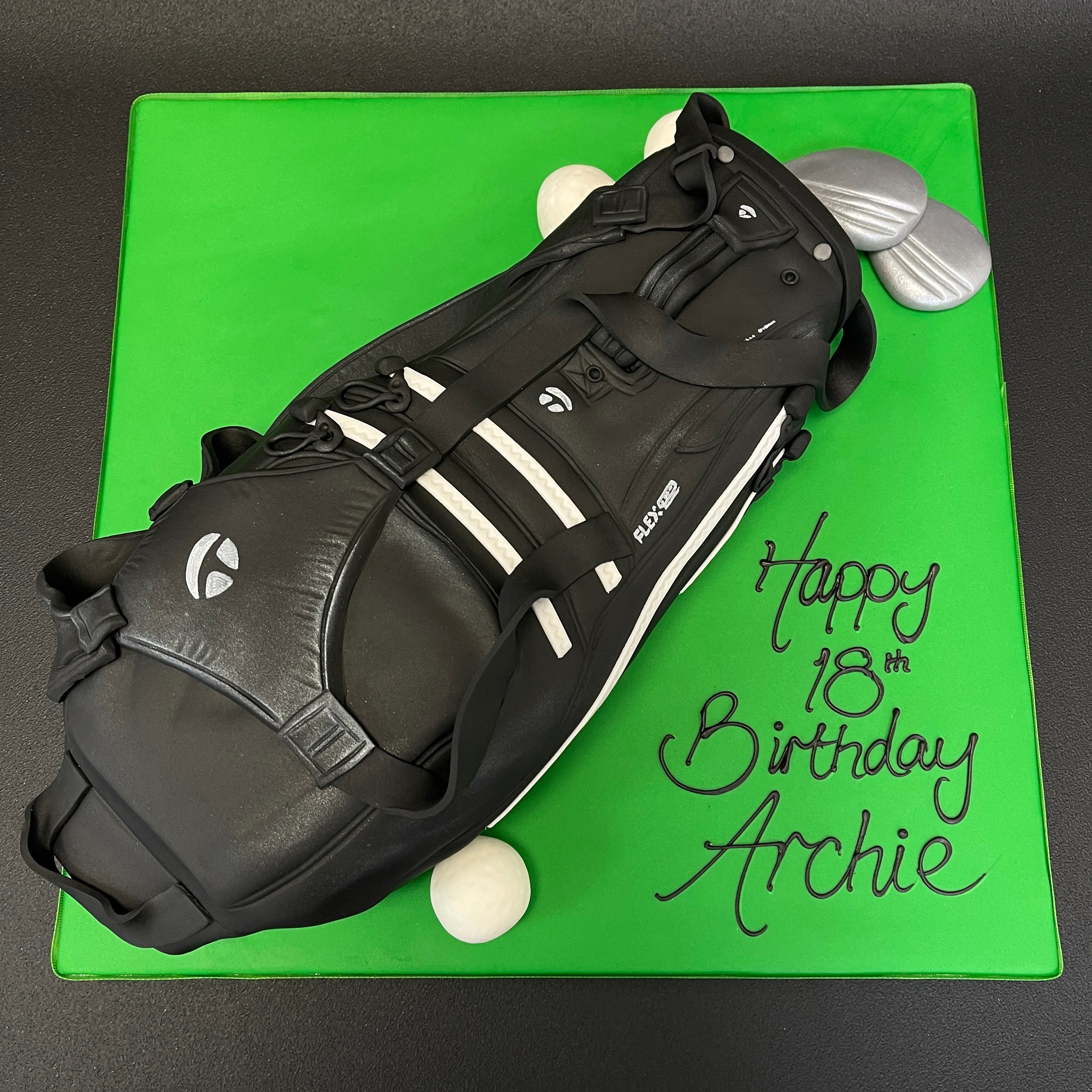 Bespoke cake shaped like a detailed Taylor Made golf bag with clubs, crafted for a celebration in Solihull, West Midlands.