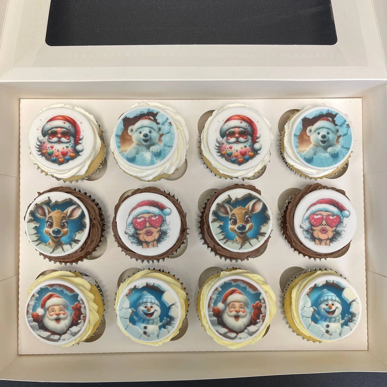 Festive Christmas-themed cupcakes decorated with colourful icing and edible images of traditional holiday motifs like stockings, ornaments, and holly leaves in UK English.