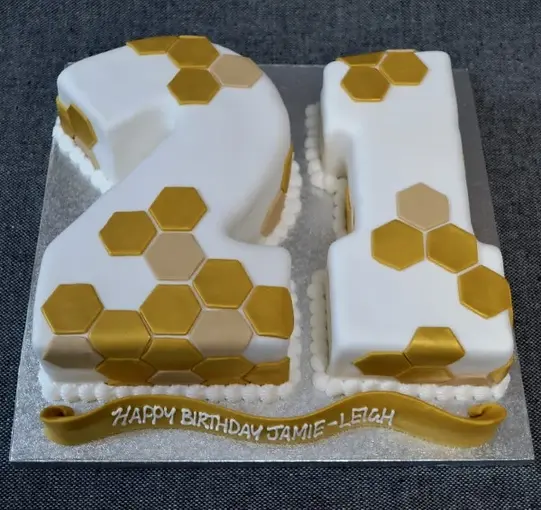 Bespoke hexagon-patterned celebration cake with fig decorations, crafted in Solihull, West Midlands.