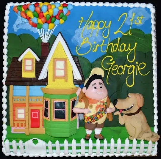 Bespoke UP-themed cake with colorful balloons and character topper, crafted in Solihull, West Midlands.