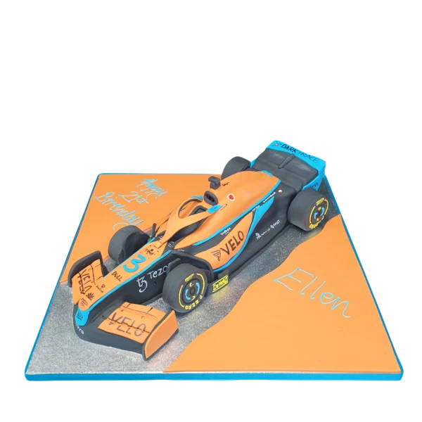 Bespoke Formula 1 McLaren car cake with detailed orange and black design, crafted in Solihull, West Midlands celebration.