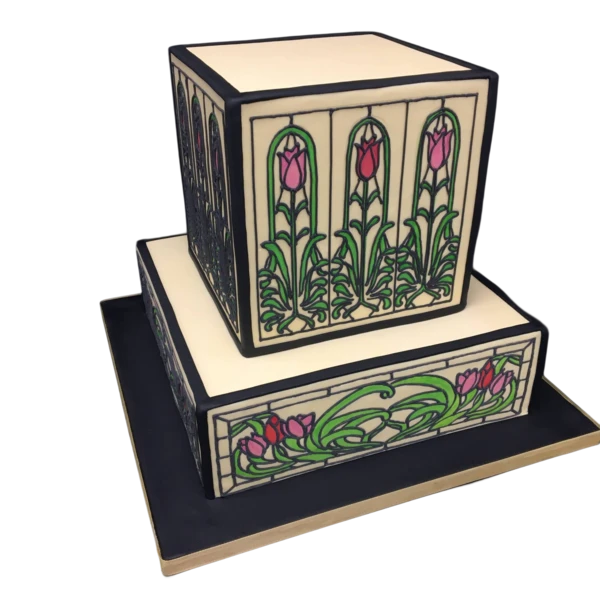 Two-tiered wedding cake with stained glass effect, floral sugar paste designs in pink and green.