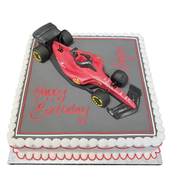 A stunning Formula 1 car-shaped cake inspired by Ferrari, perfect for racing enthusiasts and special occasions.