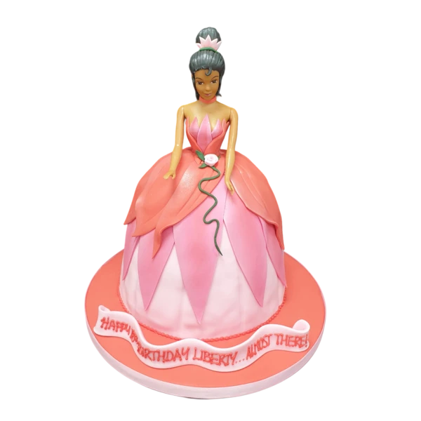 Bespoke Princess Doll cake with pink frosting and edible crown decoration in Solihull, West Midlands.