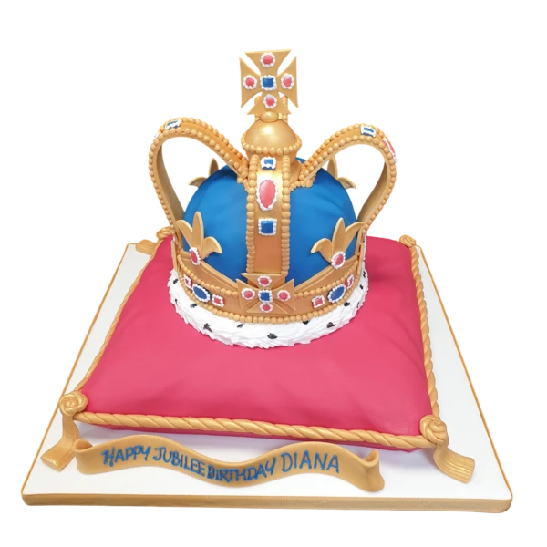 Bespoke cake shaped like a royal crown resting on a quilted cushion, crafted in Solihull, West Midlands.