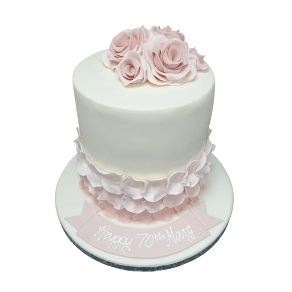 Tall bespoke cake adorned with delicate blush rose petals, perfect for celebration in Solihull, West Midlands.