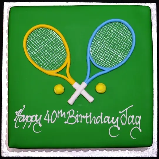 Bespoke celebration cake featuring edible tennis racquets and balls, crafted in Solihull, West Midlands.
