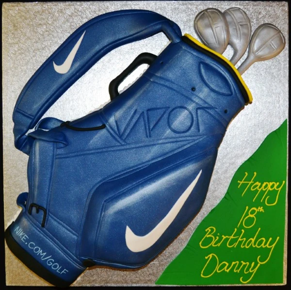 Bespoke cake shaped like a Nike golf bag with detailed logos and golf clubs, crafted in Solihull, West Midlands.