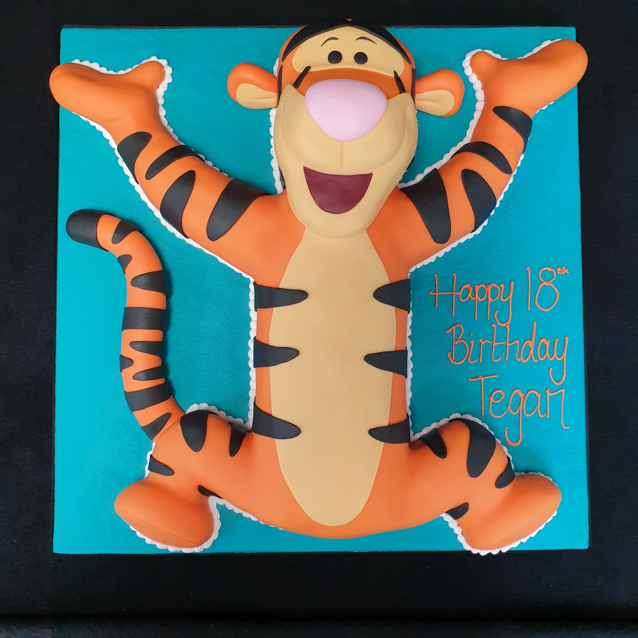 Bespoke Tigger-themed cake with vibrant orange and black stripes, crafted for celebration in Solihull, West Midlands.