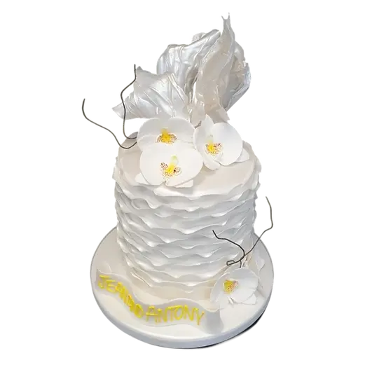 Bespoke cake with delicate ruffles and orchid decorations, crafted in Solihull, West Midlands for celebration.