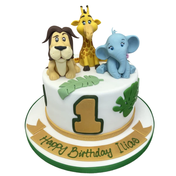 Bespoke celebration cake with lion, giraffe, and elephant figures, crafted in Solihull, West Midlands.