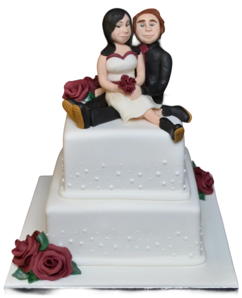 Two-tier wedding cake with sugar paste couple topper and burgundy roses.