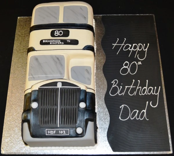 Bespoke cake shaped like an old West Midlands bus, detailed with windows and signage, Solihull, West Midlands.
