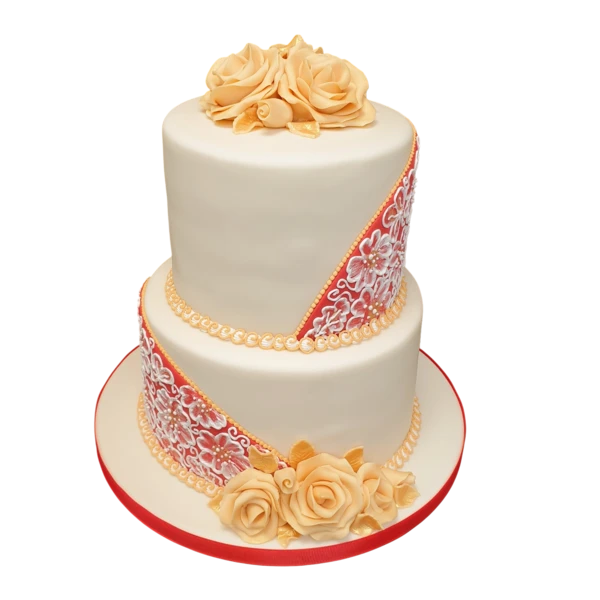 A two-tier wedding cake with sugar roses and red lace accents.