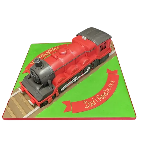 Bespoke steam train cake with intricate edible wheels and smoke details, crafted in Solihull, West Midlands.