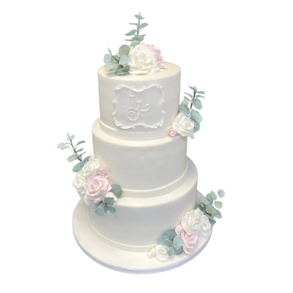 Three-tiered wedding cake with sugar paste flowers and personalised monogram.