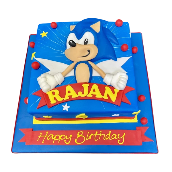 Sonic themed birthday cake with blue and white fondant icing, featuring iconic character elements like rings and lightning bolts, perfect for gaming fans.