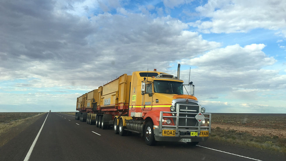 Road train truck travelling on an open highway, representing long-distance freight and supply chain resilience.