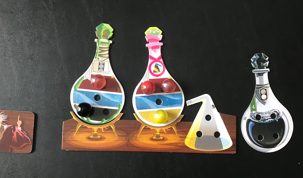 Once the potion is created, you can flip over the tile to see the art, rather than the ingredients. To drink it, just rotate the tile 180 degrees. You don't discard the potion when you drink it. You get credit for making them, not for keeping them.