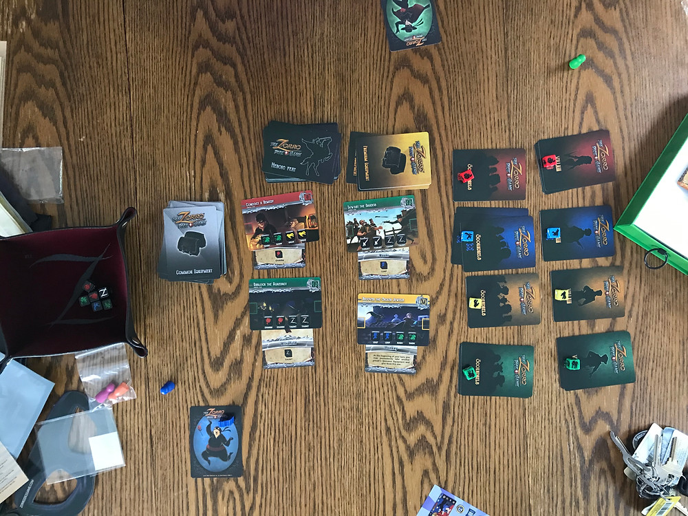 The initial setup for The Zorro Dice Game, including the Heroes and Villains expansion and all Kickstarter stretch goal rewards
