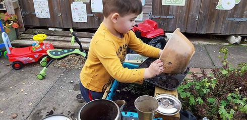 busy in mud kitchen.jpg