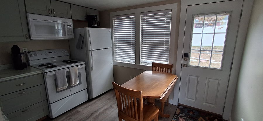Dining table and window inside the Ladybug Bungalow studio.