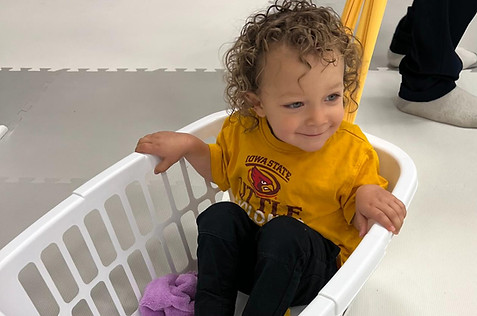 Toddler in hamper at Tuneful Journey