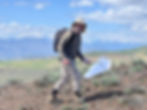 Man walking wit insect net in a desert landscape
