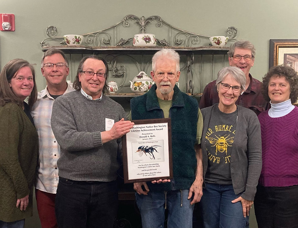 Don Rolf surrounded by family and friends receiving an award