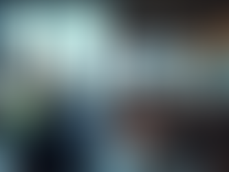 Modern office space bustling with professionals working on computers, set against a stunning cityscape featuring a mix of historic and contemporary architecture.